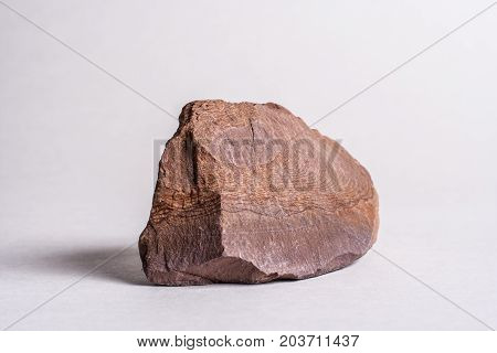 Brownish Red Siltstone Noduleon A White Background.
