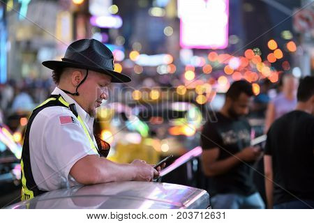 NEW YORK CITY - AUG. 26 : Unidentified people on the Times Square in Manhattan on August 26 2017 in New York City NY. Times Square is a major tourist destination and entertainment center.