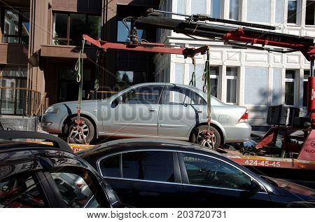 NIZHNY NOVGOROD, RUSSIA - AUGUST 31, 2017: An improperly parked car in Nizhny Novgorod is being towed by tow truck.