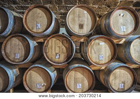 Picture of wooden wine barrels in the wine cellar.