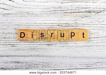 DISRUPT word made with wooden blocks concept