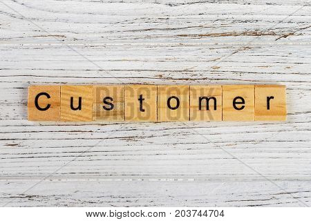 CUSTOMER word made with wooden blocks concept