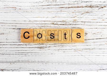COSTS word made with wooden blocks concept