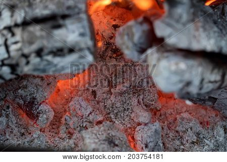 Burnig charcoals and remaining ashes with ember