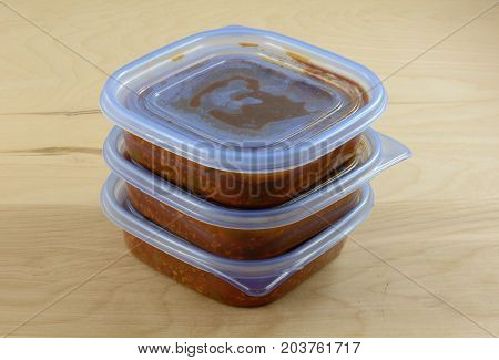 Batch of cooked turkey spaghetti sauce pit in storage containers for freezing for quick future meals