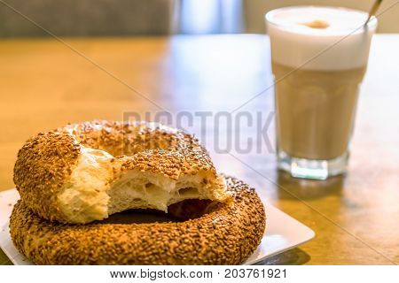 Turkish traditional sesame bagels. Simit and latte macchiato in the cafe