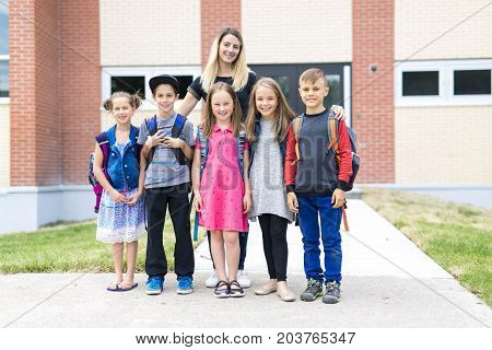 The Great Portrait Of School Pupil Outside Classroom Carrying Bags