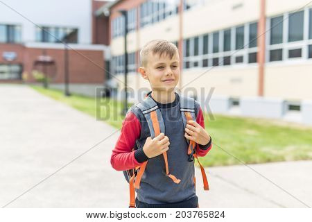 The Great Portrait Of School Pupil Outside Classroom Carrying Bags