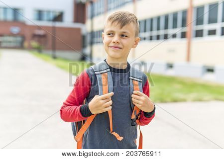 The Great Portrait Of School Pupil Outside Classroom Carrying Bags