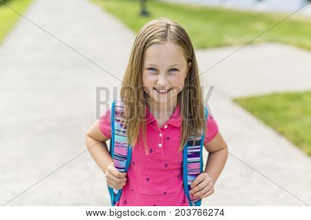 The Great Portrait Of School Pupil Outside Classroom Carrying Bags