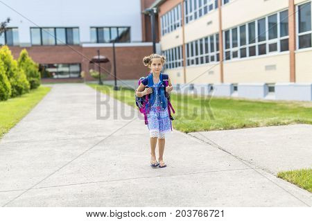 The Great Portrait Of School Pupil Outside Classroom Carrying Bags