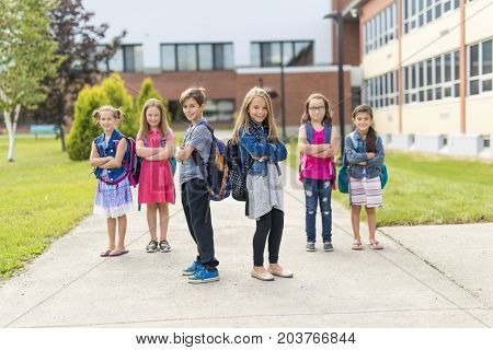 The Great Portrait Of School Pupil Outside Classroom Carrying Bags