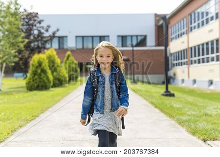 The Great Portrait Of School Pupil Outside Classroom Carrying Bags