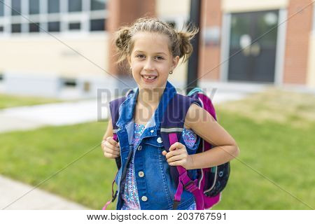 The Great Portrait Of School Pupil Outside Classroom Carrying Bags