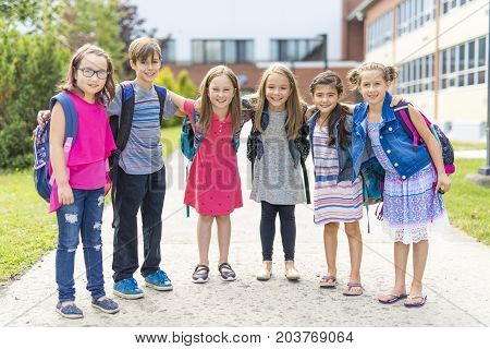 The Great Portrait Of School Pupil Outside Classroom Carrying Bags