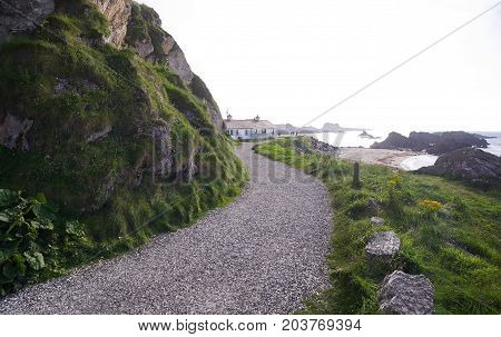 Path leading to houses in Ballintoy Harbour, Antrim, Northern Ireland