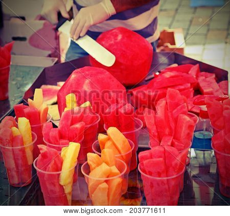 Skilled Fruit-veggie Cuts Watermelon With A Large And Sharp Knif