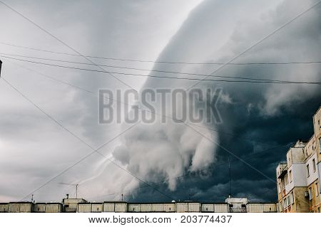 Storm clouds a hurricane is coming. Beautiful storm sky with clouds over the city apocalypse like