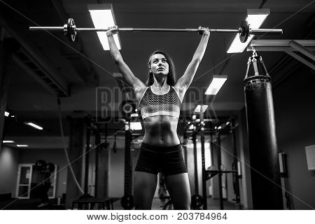 Young fitness woman lifting a weight fit in the gym. Fitness woman deadlift barbell.  woman.  style.  and fitness