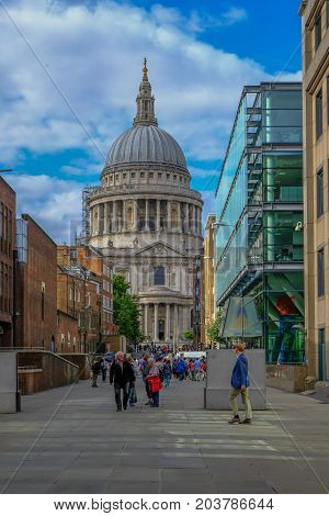 London UK - August 3 2017: Looking towards St. Paul's Cathedral from the Millennium Bridge. Shows lots of people walking on the pathway linking up to the Millennium Bridge.
