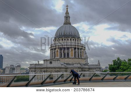 London UK - August 3 2017: St. Paul's Cathedral view from the top of 1 New Change. Shows a couple looking over the railing in the foreground.