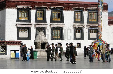 Chinese Soldiers Walking At The Jokhang Temple
