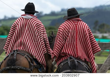 June 3 2017 Machachi Ecuador: cowboys from the Andes called 'chagra' on horseback wearing striped ponchos