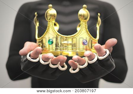 Boxing king fighter champion best of the best concept. Fighting competition winner man holds in hand his golden award golden crown.