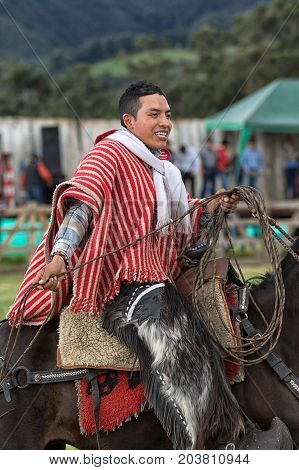 June 3 2017 Machachi Ecuador: young cowboy on horse back in traditional wear in the Andes region