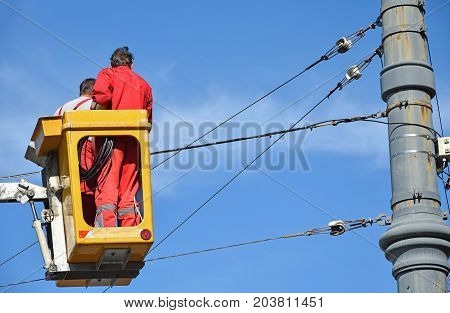 Electricians at work in height in a lift