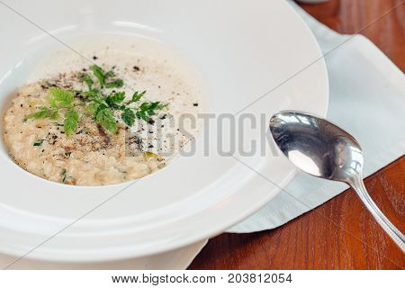 Bowl Of Oats Porridge. Healthy Breakfast On Wooden Table