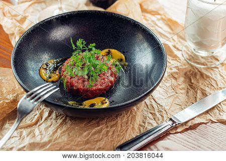 Above View Of Salmon Tartar On A Dark Wooden Background, Studio Shot