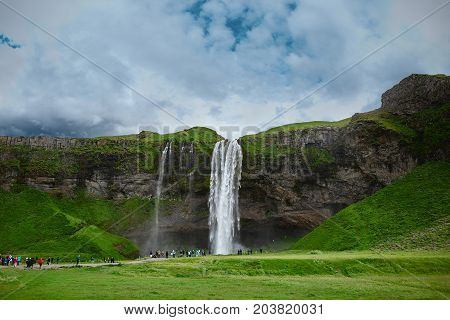 famous Seljalandsfoss waterfall in southern Iceland. treking in Iceland. Travel and landscape photography concept