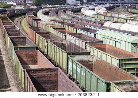 A lot of empty rail cars. A loaded coal train transporting coal. A lot of different cars