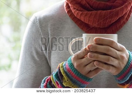 A young man holding a Cup of tea and lemon. Cold, cold, disease.