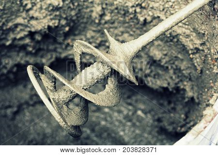 concrete mixing with electrical drill and mixer .