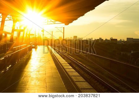 Railway station at platform in the eveningSunset of railroad tracks