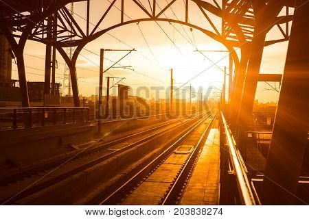 Railway station at platform in the eveningSunset of railroad tracks