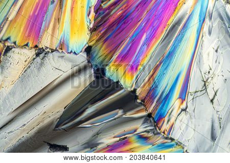 colorful microscopic shot of sugar micro crystals in polarized light