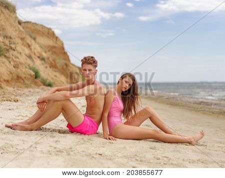 Full length photo of travel vacation and lifestyle concept. Enjoying beautiful sunset on the beach together. Honeymoon vacation. Natural and sea view on the background.