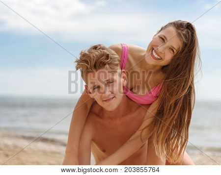 Close-up picture of travel vacation and lifestyle concept. Enjoying beautiful sunset on the beach. Natural and sea view on the background. Joyful and romantic couple on sunset, at the golden beach.