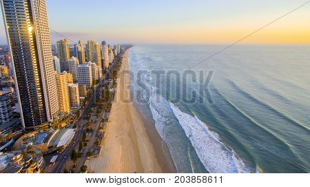 GOLD COAST, AUSTRALIA - SEPTEMBER 3 2017: Aerial view facing down with a view of the famous beach of Surfers Paradise and city centre at sunrise.