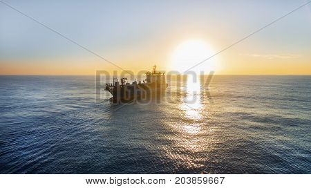 GOLD COAST, AUSTRALIA - SEPTEMBER 10 2017: Balder R Hopper Dredger on the open sea's silhouette at sunrise.