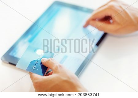 Online shopping in internet concept. Man use credit card and tablet.