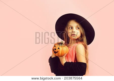 Child In Witch Costume And Jack O Lantern