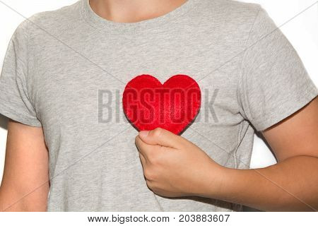 Young men hold red heart in hand.