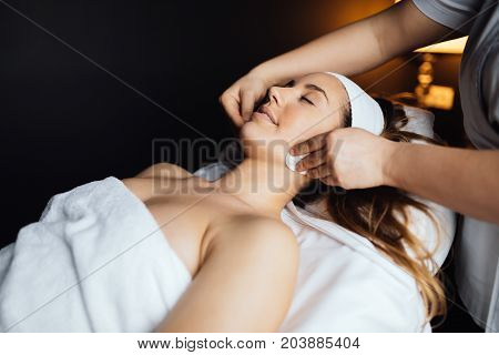 Beautiful young woman enjoying massage and rejuvenating