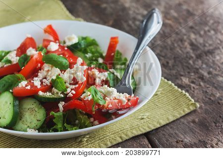 Shopska Salad In A White Plate On A Wooden Background, Close-up