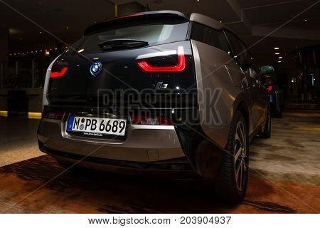 BERLIN - NOVEMBER 28 2014: Showroom. The BMW i3 previously Mega City Vehicle (MCV) is a five-door urban electric car developed by the German manufacturer BMW. Rear view.
