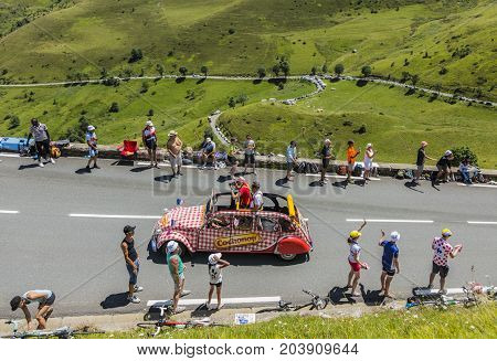 Col de PeyresourdeFrance- July 23 2014: Cochonou vehicle passing in the Publicity Caravn on the road to Col de Peyresourde in Pyrenees Mountains during the stage 17 of Le Tour de France 2014.